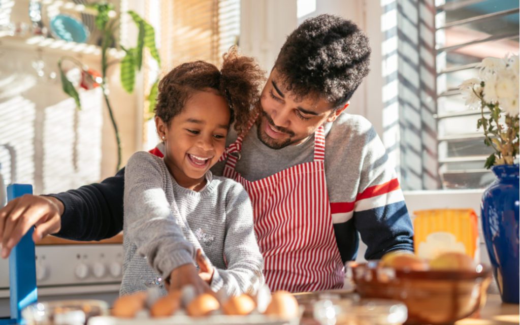 Father and daughter cooking breakfast together.
